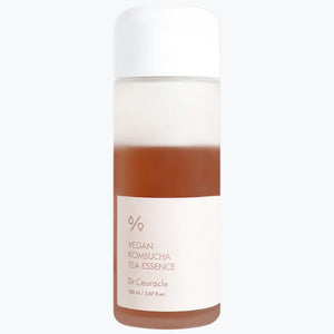 Ansiktsessens i plastflaska med vit kork, brun vätska och etikett Dr.Ceuracle 150 ml