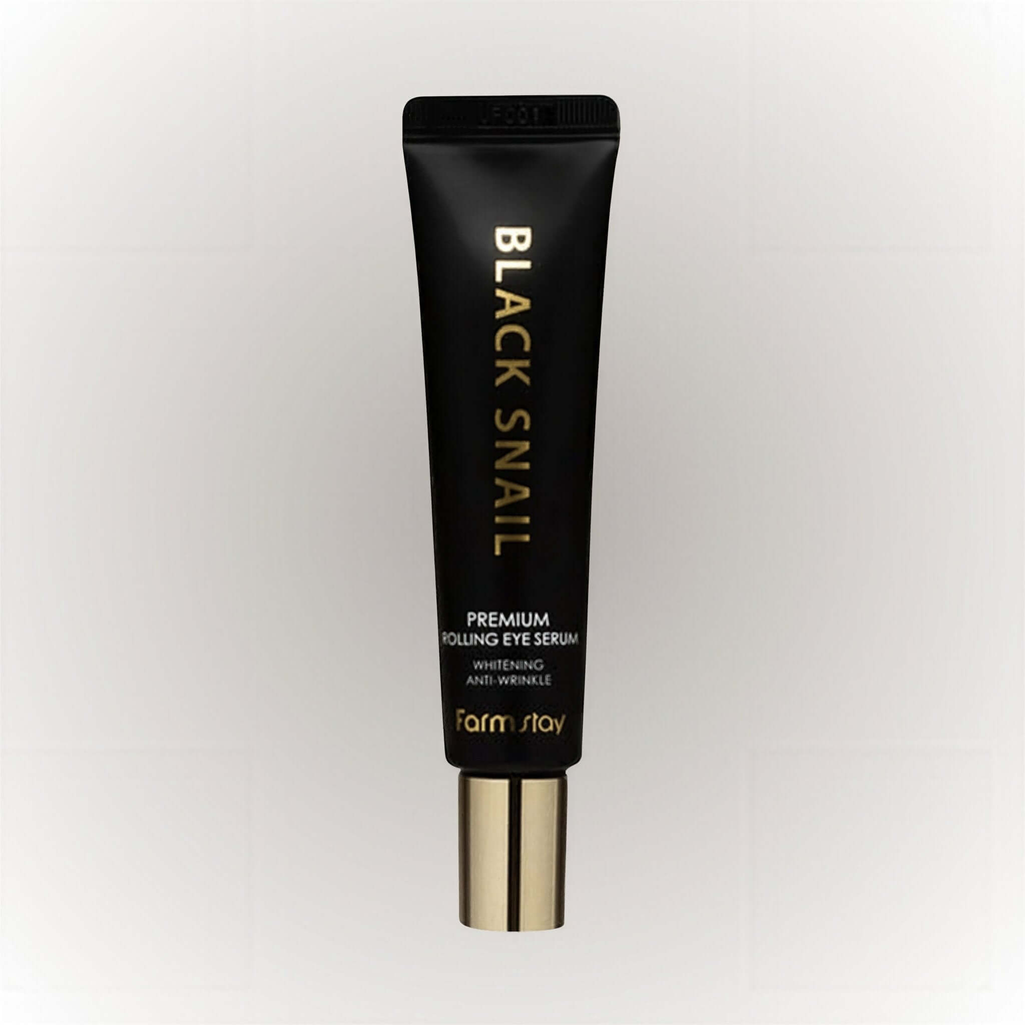 Farm Stay Black Snail Premium Rolling Eye Serum i en svart förpackning med guldbokstäver.