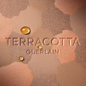 Bronspuder med terrakotta-ton och texten 'Terracotta' 'Guerlain' på ytan