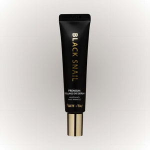 Farm Stay Black Snail Premium Rolling Eye Serum i en svart förpackning med guldbokstäver.